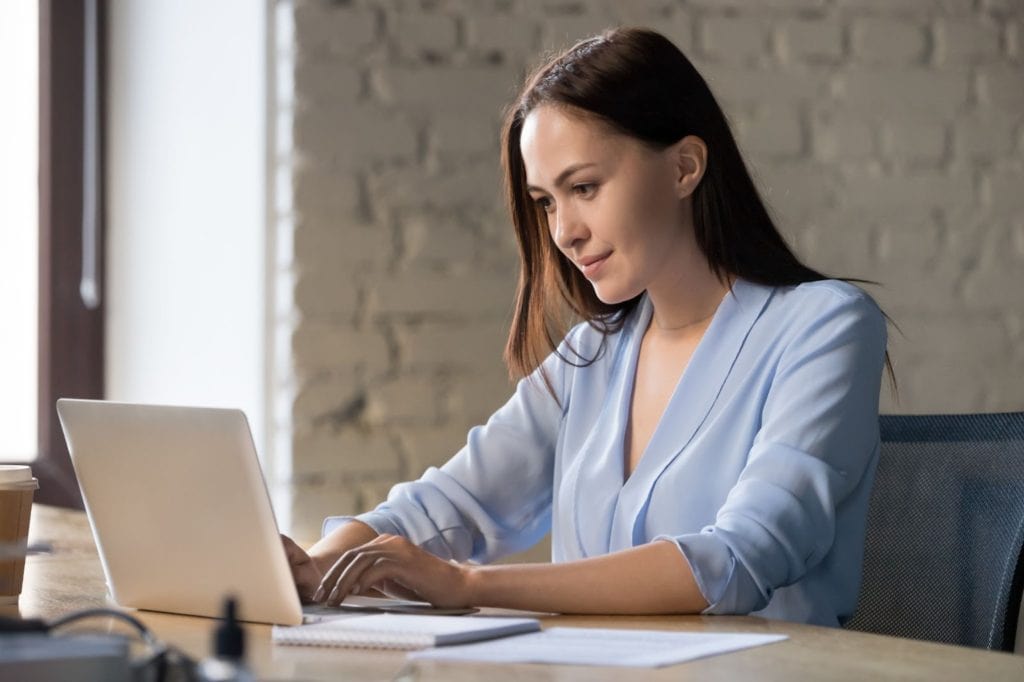 Women on Laptop writing a reminder email for no response